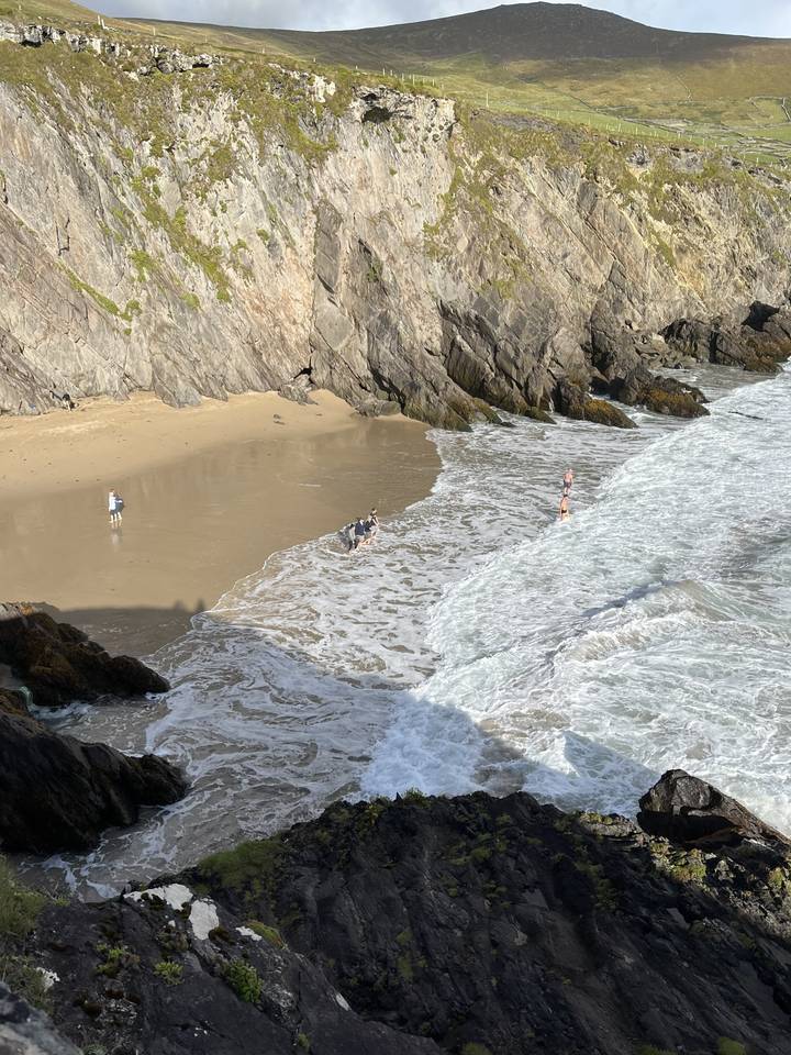 Aerial view of a beach with people and waves.