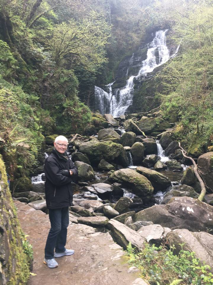 Personne debout près d'une cascade.