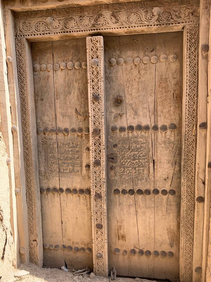 Close-up of intricately carved wooden door