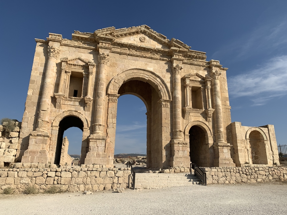 Roman arch structure with clear sky.
