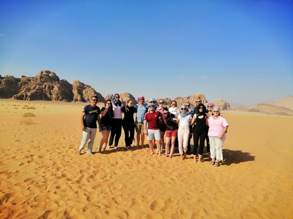 Group of people in desert landscape.