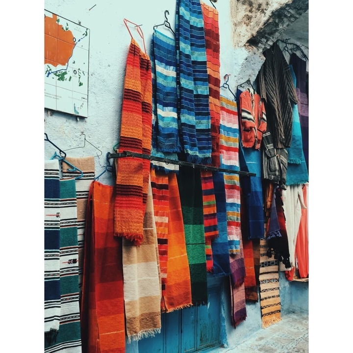 Multi-colored woven textiles on display.