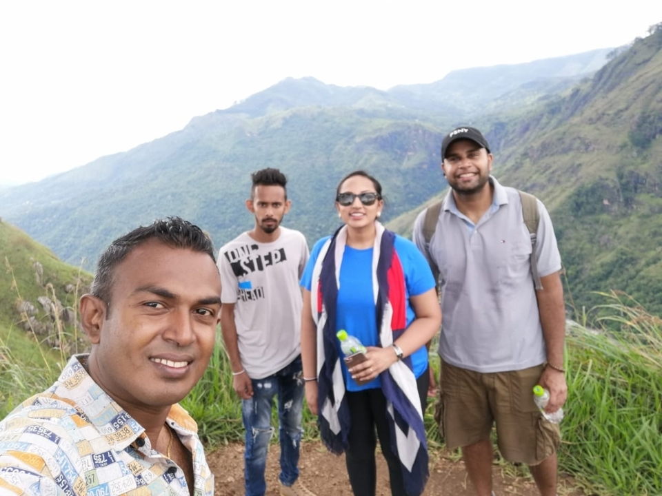 A group of people outdoors on a mountainous hike.