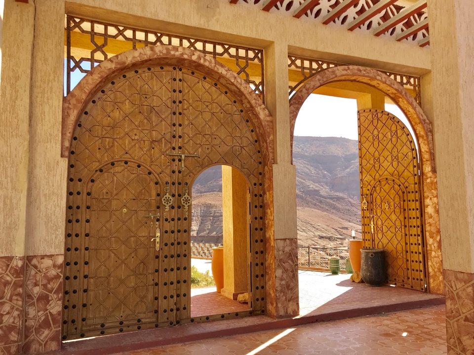 Elegant arched doors and a scenic mountain view.