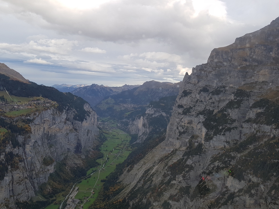 Panoramic view of a mountainous valley with cliffs on either side.