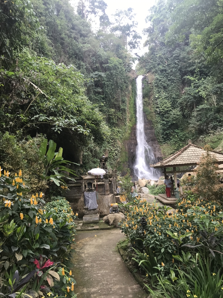 Waterfall with traditional Indonesian structures