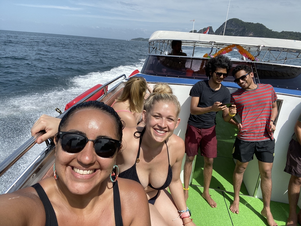 Group of people enjoying a boat ride on the ocean.