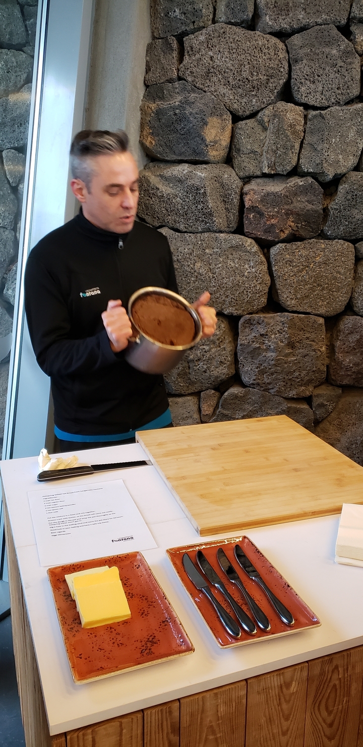 Person holding a pot in a rustic setting.