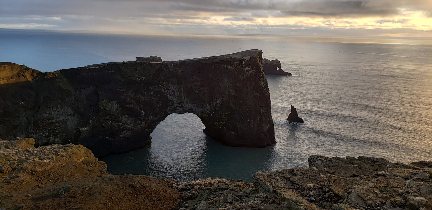 Rock arch over the sea during a scenic sunset.