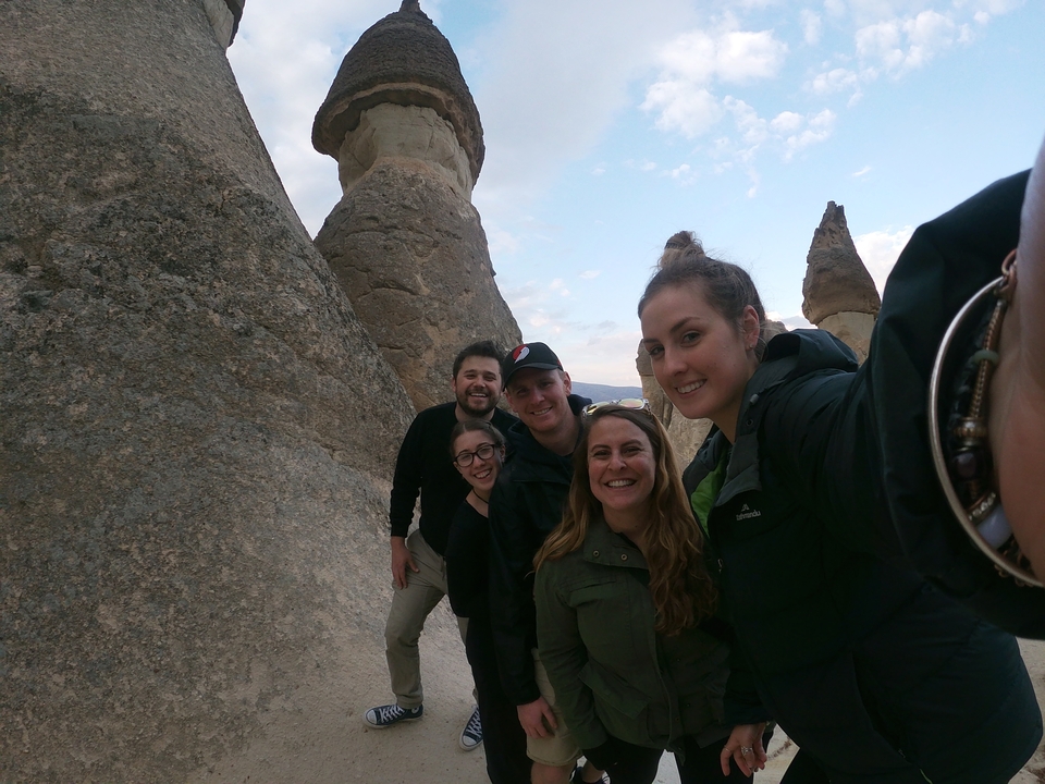Group of people taking a selfie with unique rock formations.