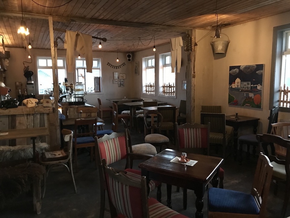 Interior of a rustic cafe with empty tables and chairs.