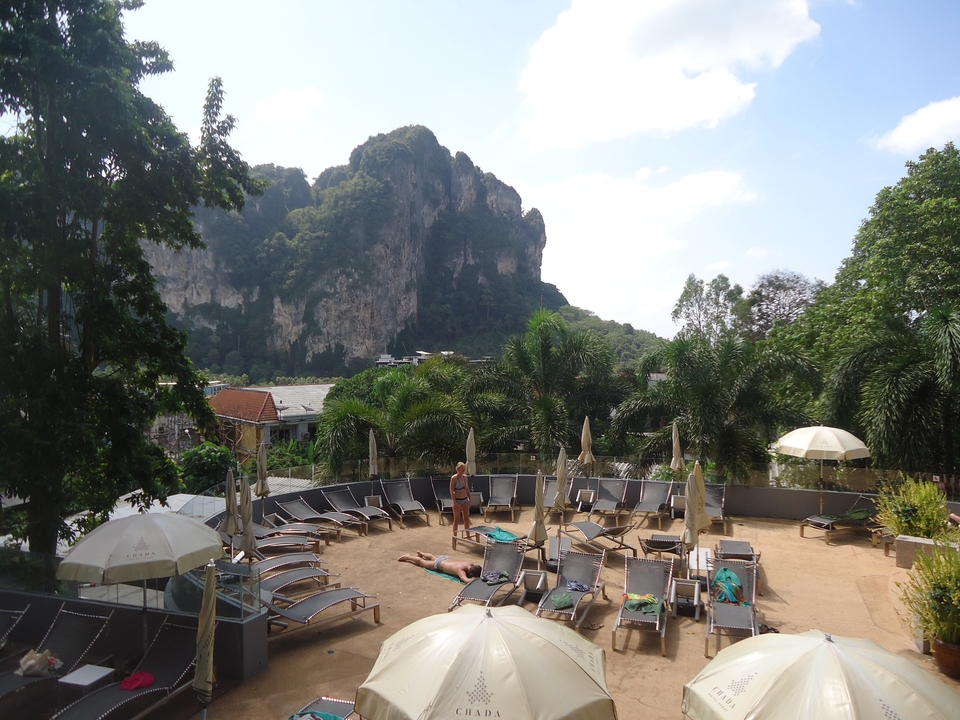 Outdoor relaxation area with sunbeds and a scenic mountain view.