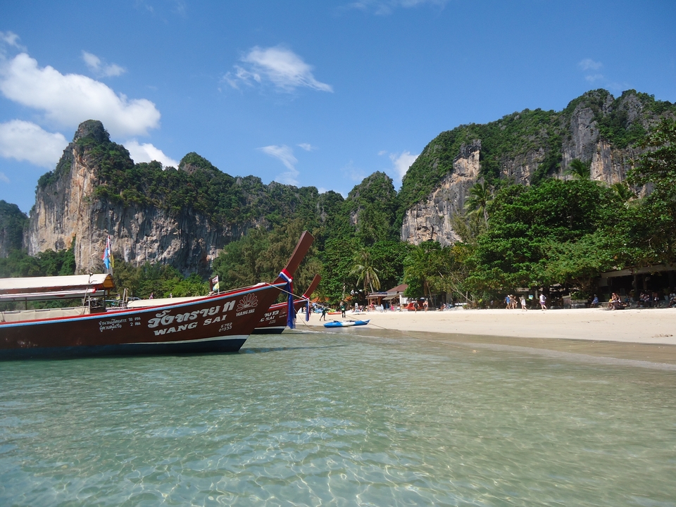 Traditional long-tail boat on a tropical beach.