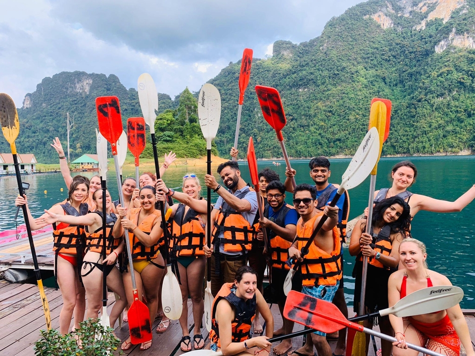 Group of people with kayaks on a dock.