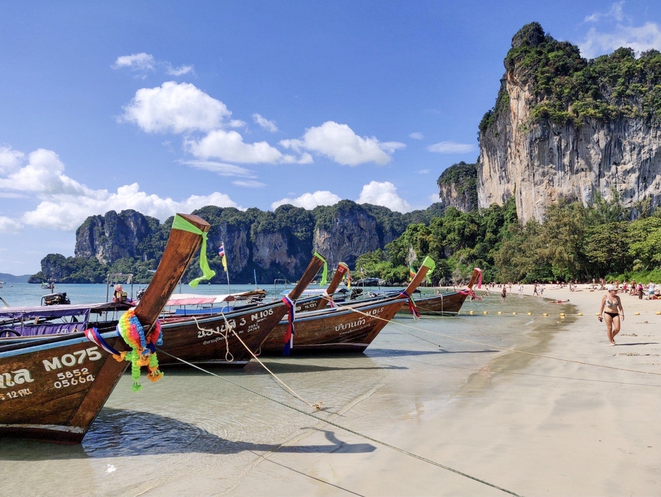 Long-tail boats on a beach in Krabi, Thailand.