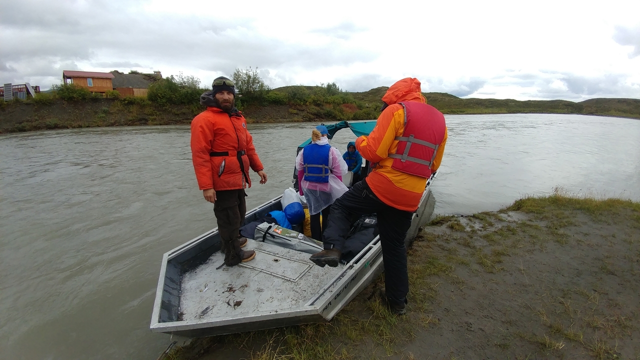 People preparing to embark on a small boat.