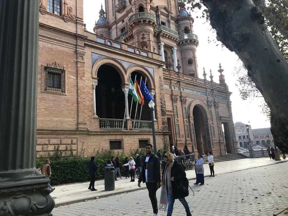 Plaza de España in Seville with its impressive building and flags.