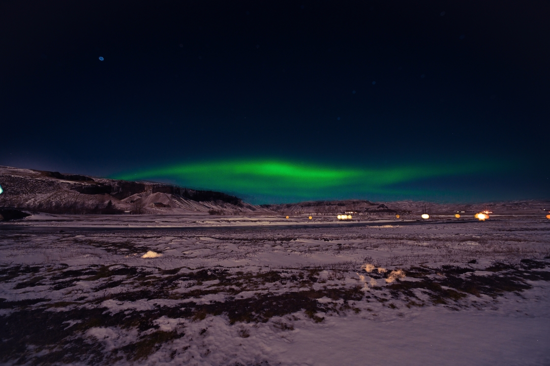Northern lights over a snowy landscape.