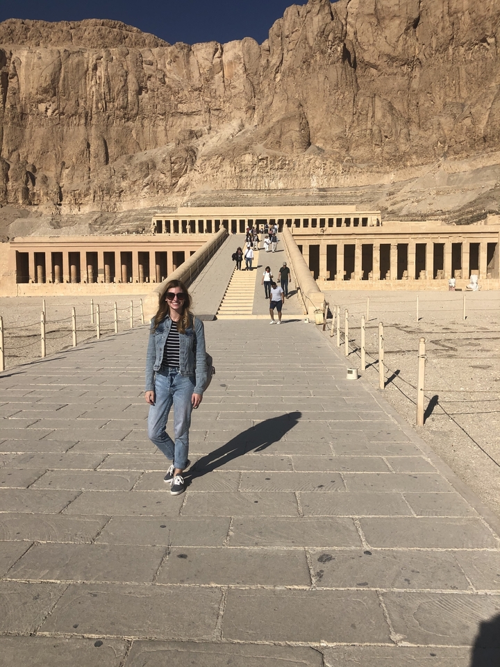 Woman posing in front of the mortuary temple of Hatshepsut.