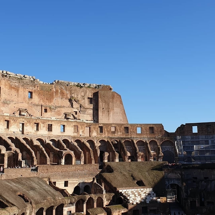 Interior view of the Colosseum with bright afternoon sunlight