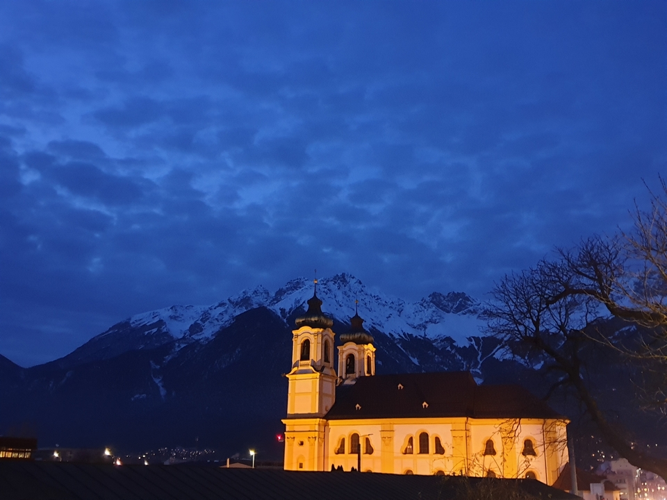 Church with mountains in the background at dusk