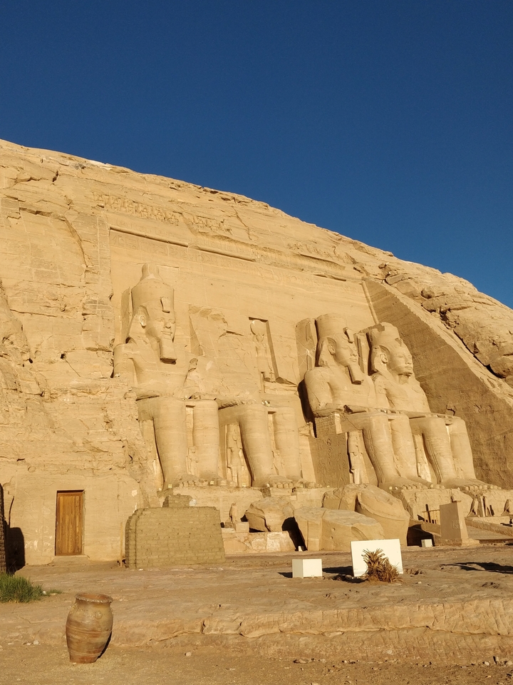 Ancient rock carvings of seated figures.
