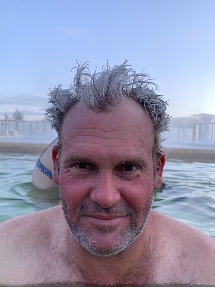 Close-up of a person with frosted hair in a hot spring.