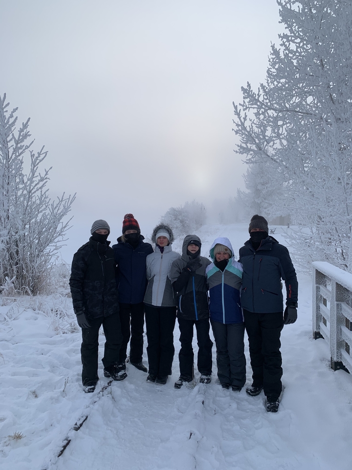 Group of people standing in snowy weather.