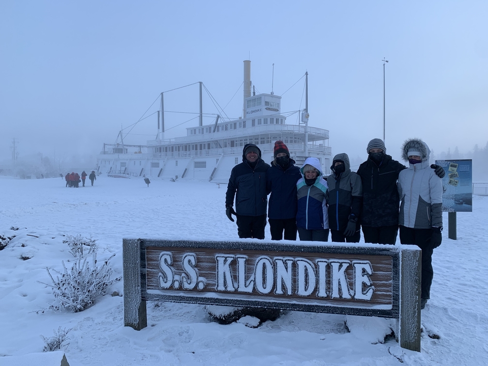 Group in front of the S.S. Klondike ship in snowy weather.