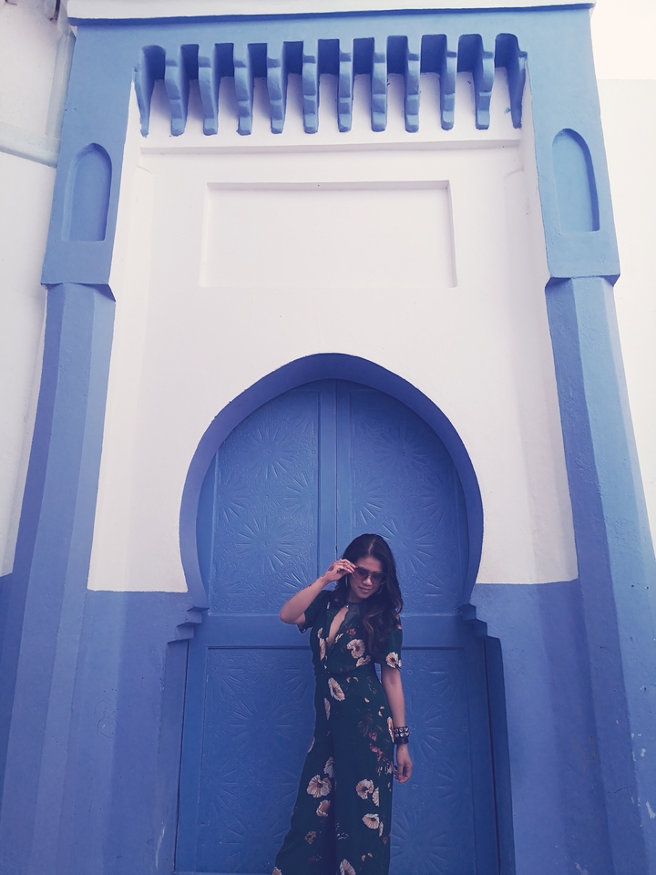 Person standing in front of a blue door.