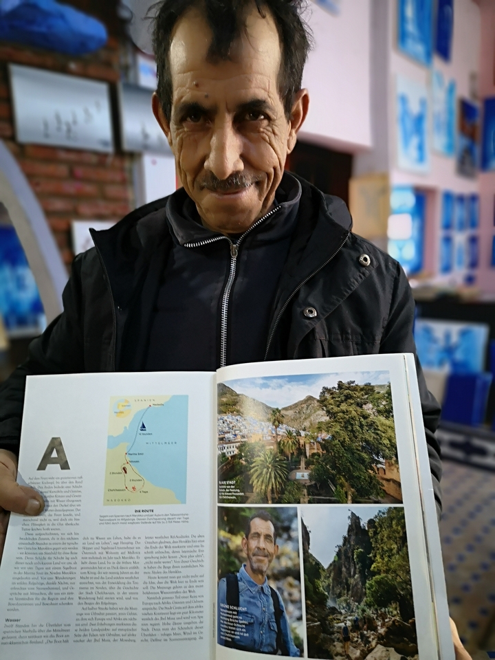 Person showing a picture book.