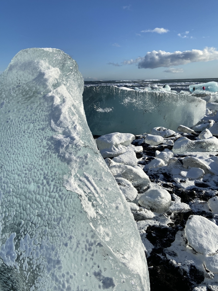 Close-up of ice formations and rocks.