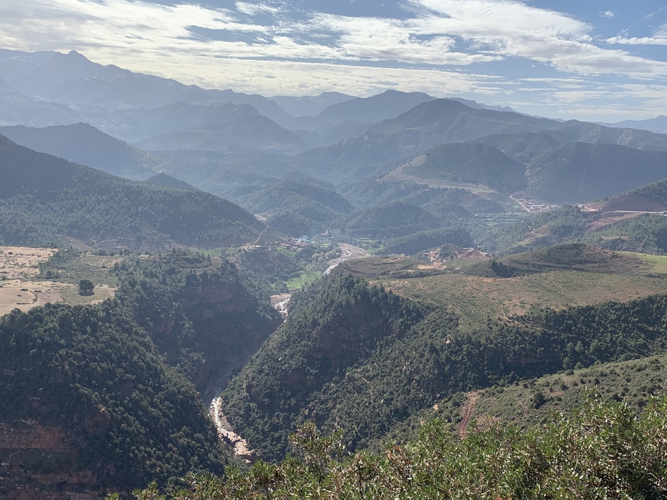 Vast mountainous landscape with valleys and small settlements.