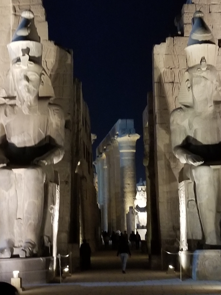 Blurred view of historical ruins at night.