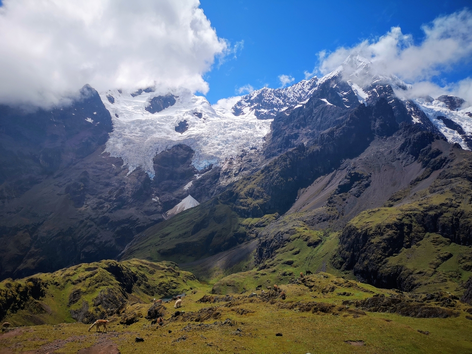 High mountain range with glaciers and clear sky.