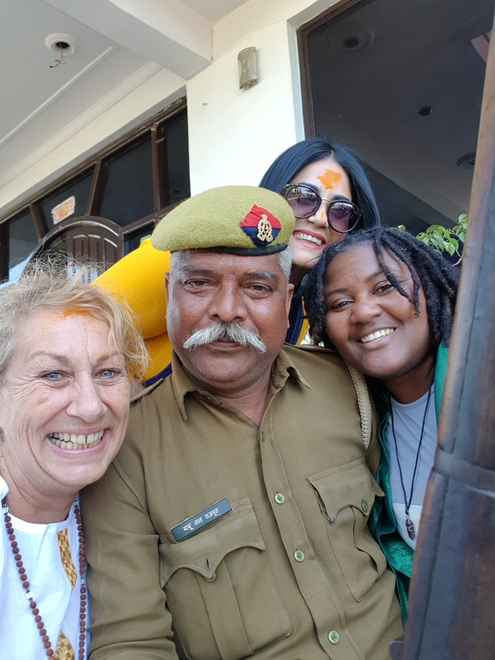 Group of people posing with a local police officer.