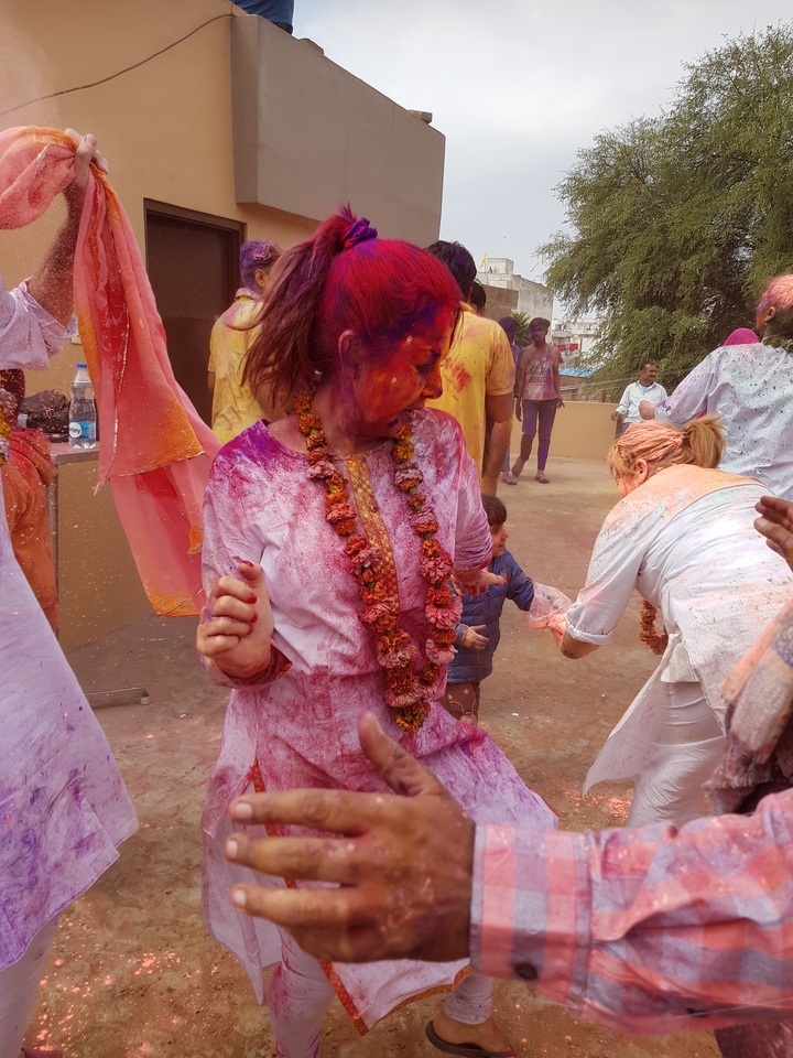 Woman celebrating Holi with colored powder.