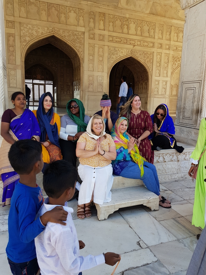 Group sitting and posing in traditional attire.