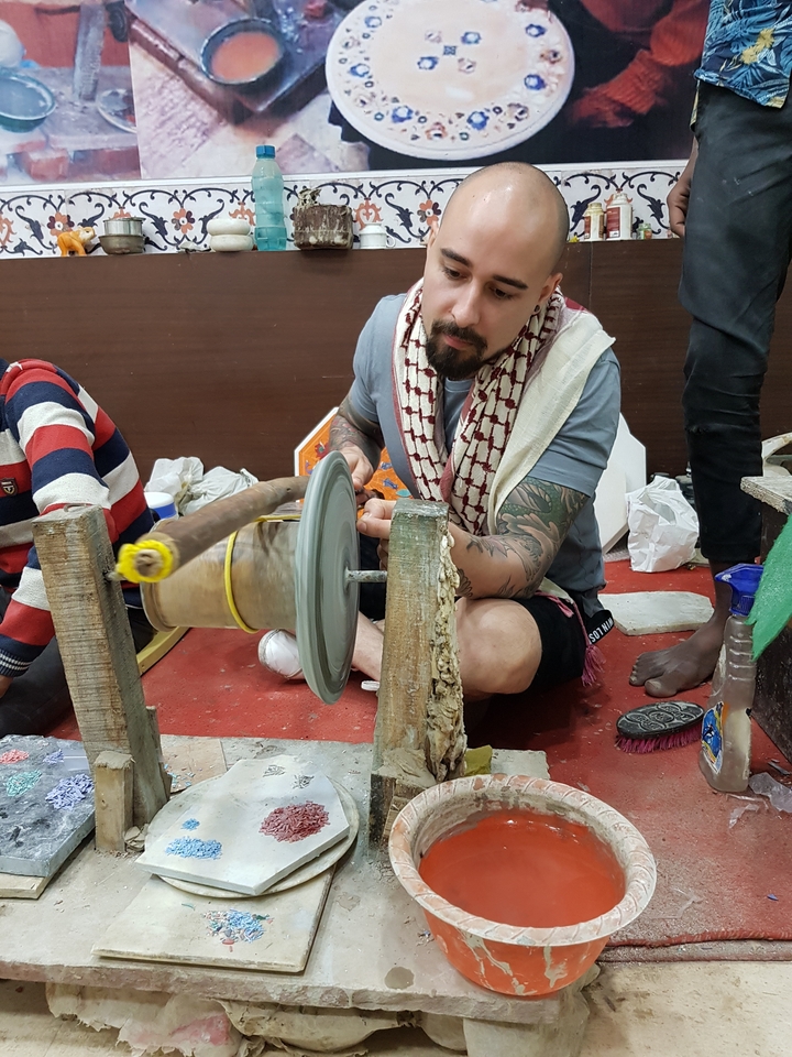 Man crafting with spinning tool.