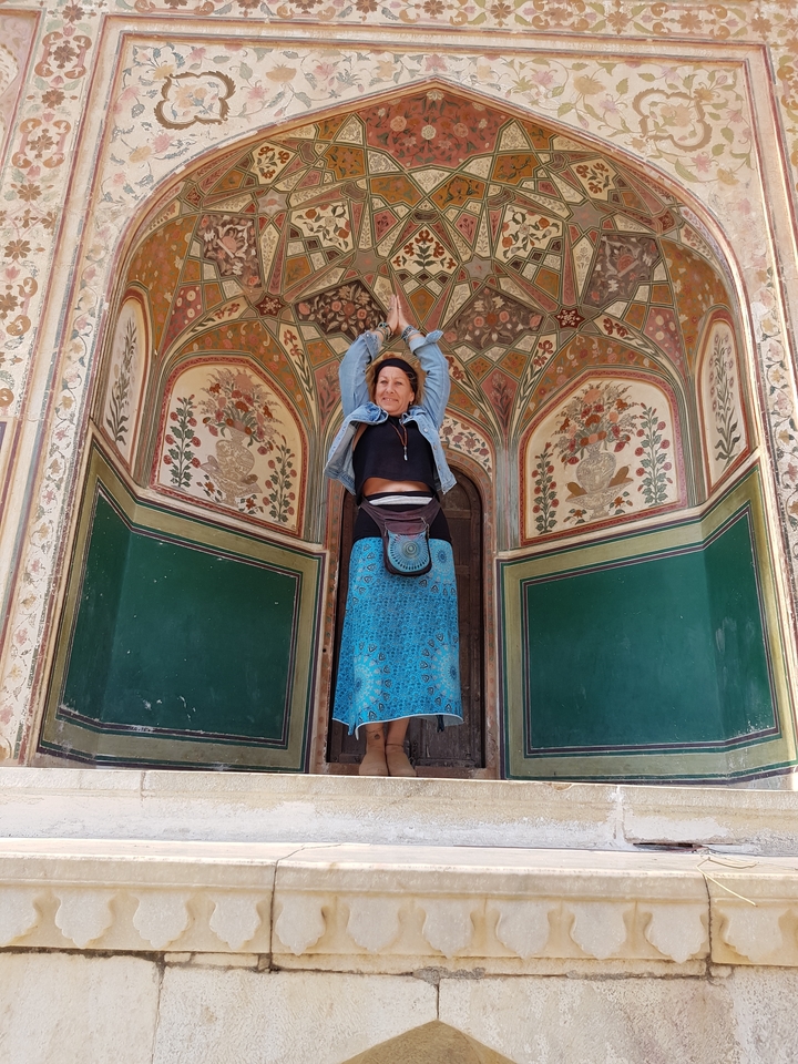 Woman posing under decorated archway.