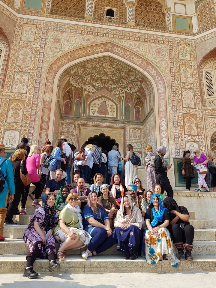 Group gathered at an intricately decorated entrance.
