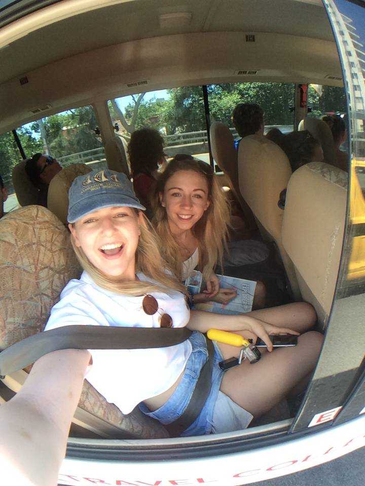 People in a vehicle smiling for a selfie