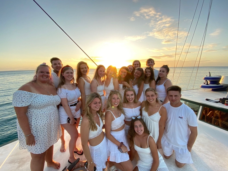 Group photo on a boat during sunset.