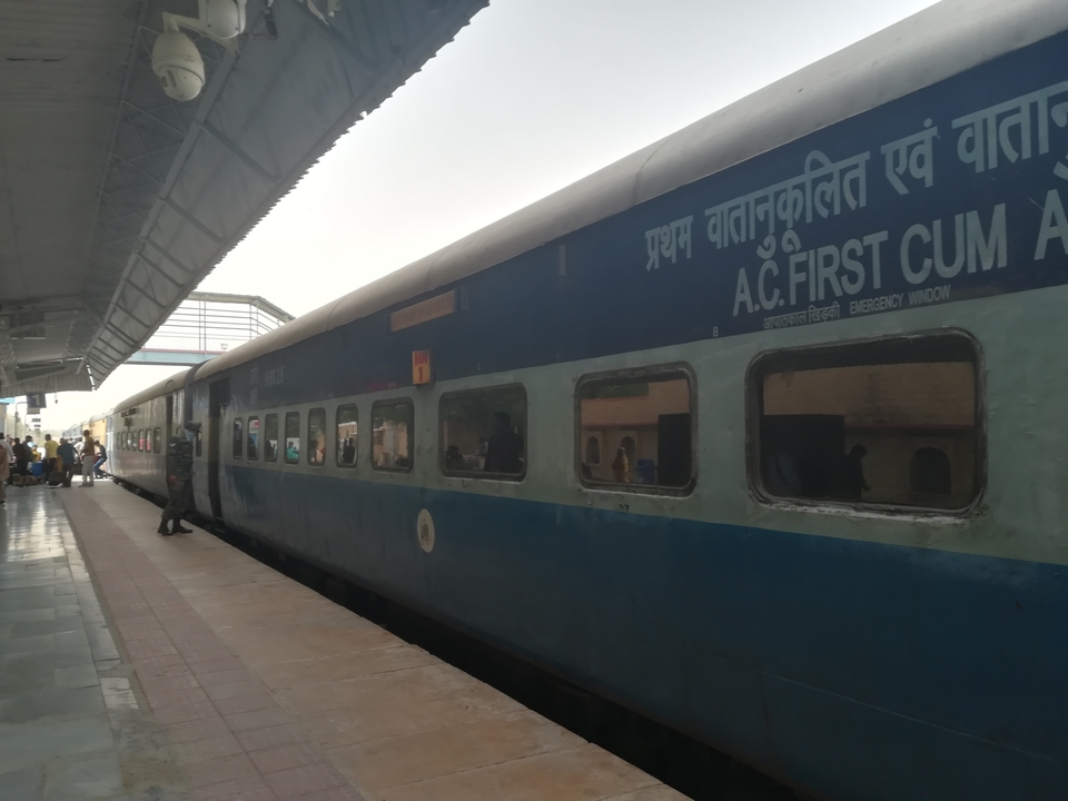 Train on a platform with visible Hindi text.