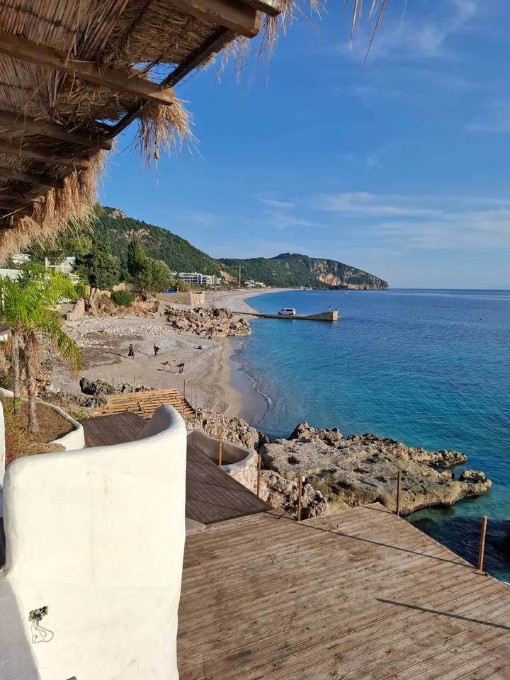 Beautiful beach with rock formations and clear blue water.