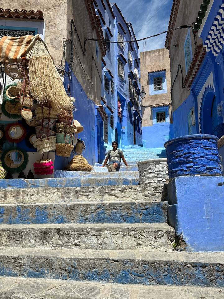 Blue painted street with a person walking.
