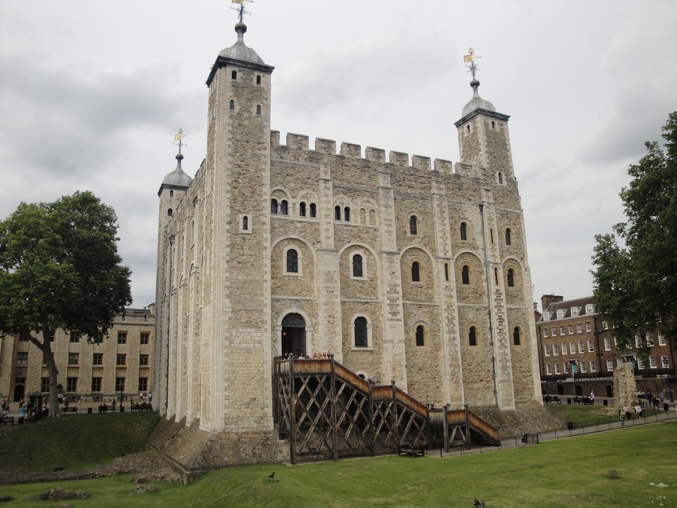 A medieval fortress with an open courtyard, cloudy sky.
