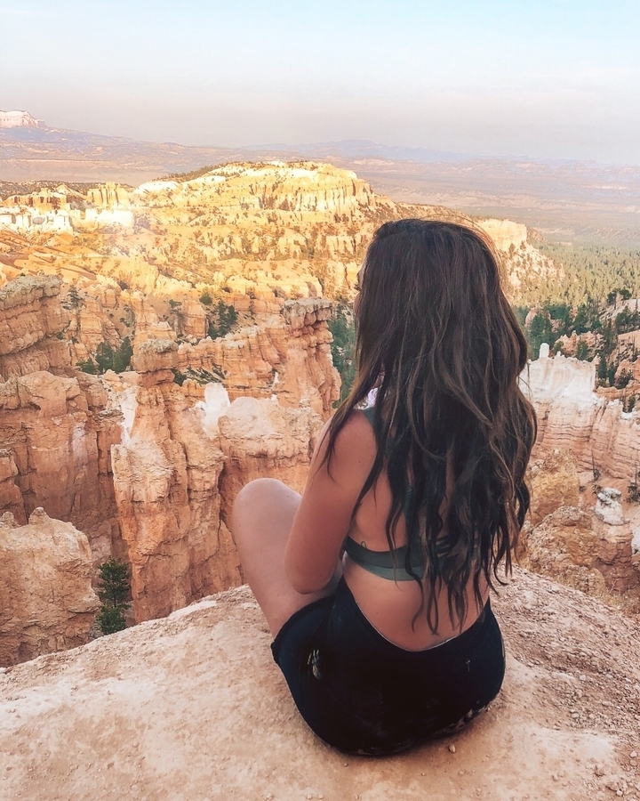 Woman watching over hoodoos in a canyon.