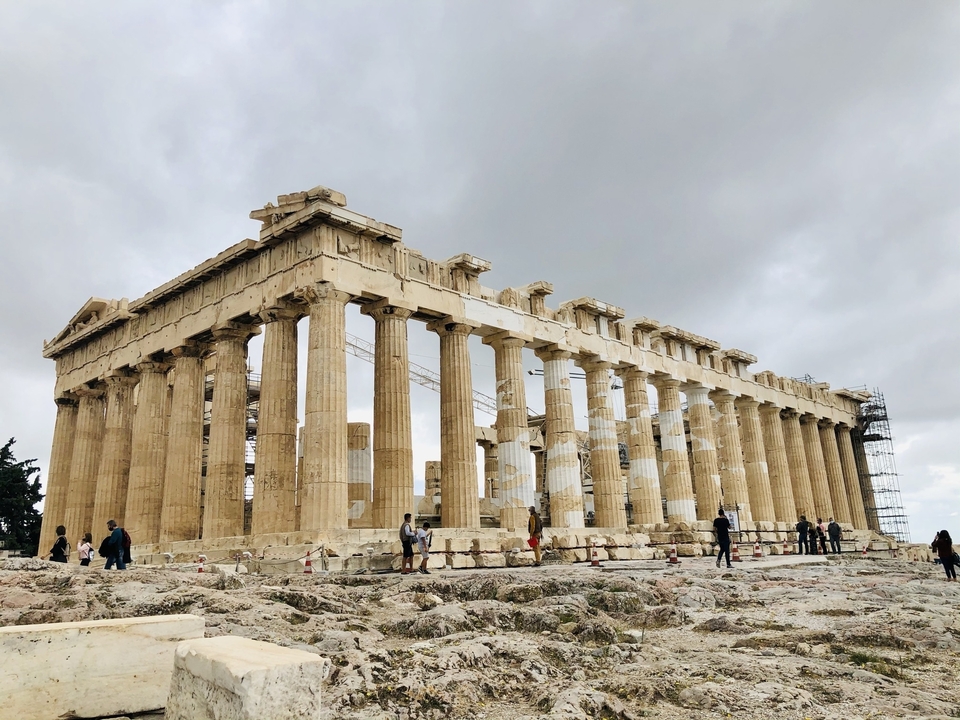 The Parthenon with scaffolding and visitors on site.