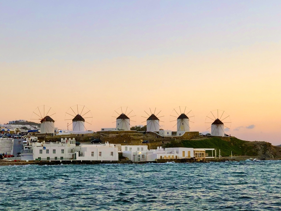 Windmills on a hill near the sea in Mykonos.